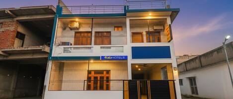 A two-story building with a sign for 'fabHOTELS'.