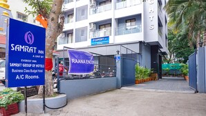 A hotel entrance with a sign for Samrat Inn, a business class budget hotel, and a Raana Encounters banner. - Fabhotel Everest Inn (Pune)