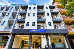 A multi-story hotel with a modern facade, air conditioning units, and a prominent 'fabHOTELS' sign. - FabHotel The Yashoobhumi (New Delhi)