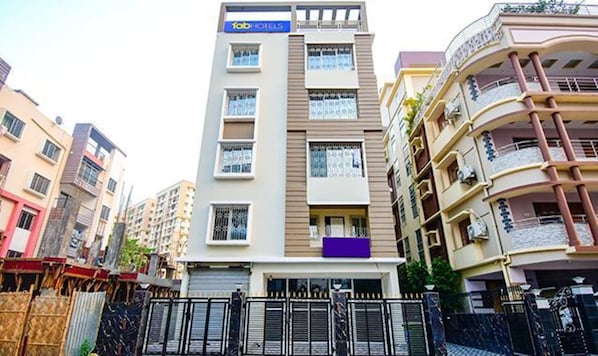 A multi-story hotel with a prominent 'fbHOTELS' sign, balconies, and a gated entrance. - FabHotel Trishiv - Newtown Kolkata (Barasat)