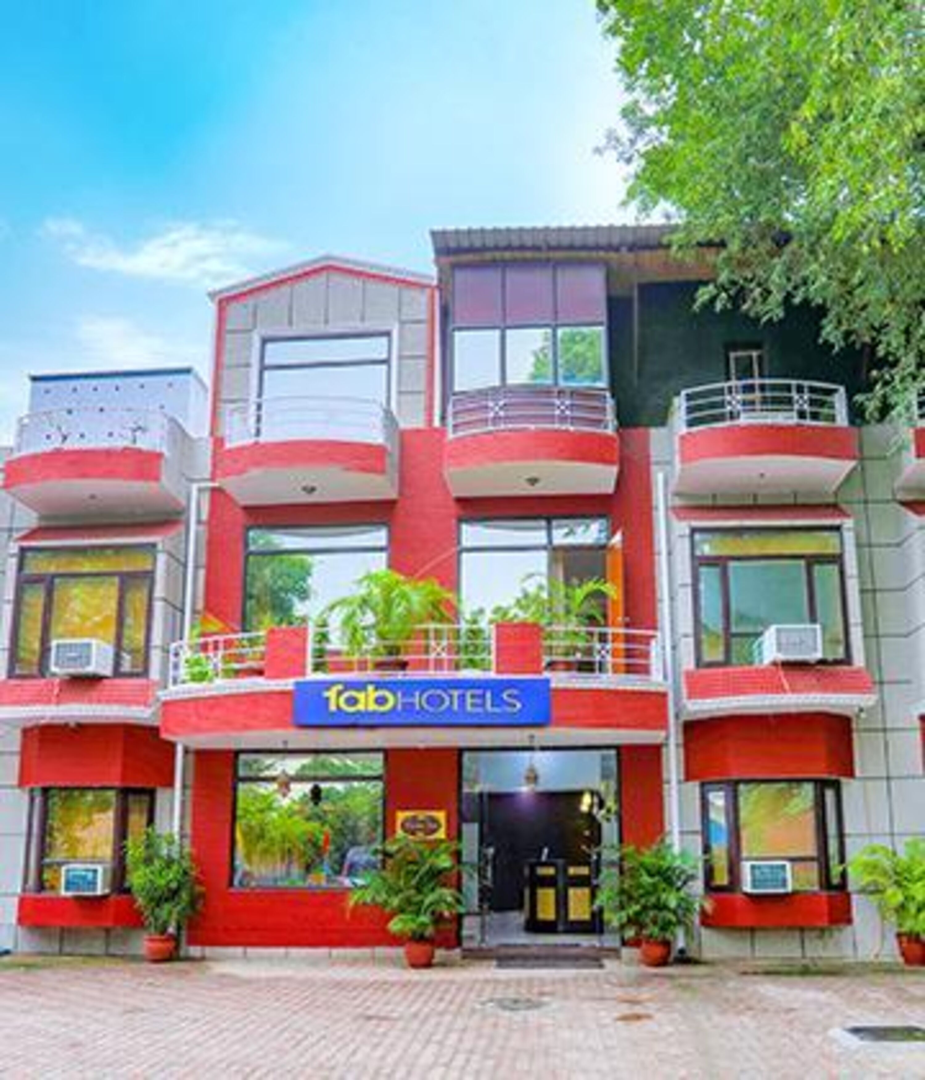 A multi-story building with a prominent 'fabHOTELS' sign.