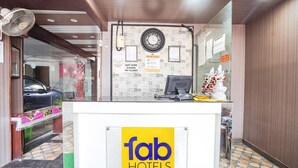 A hotel reception area with a clear sign reading "fab hotels". - Fabhotel Krishna Heights (Dehradun)
