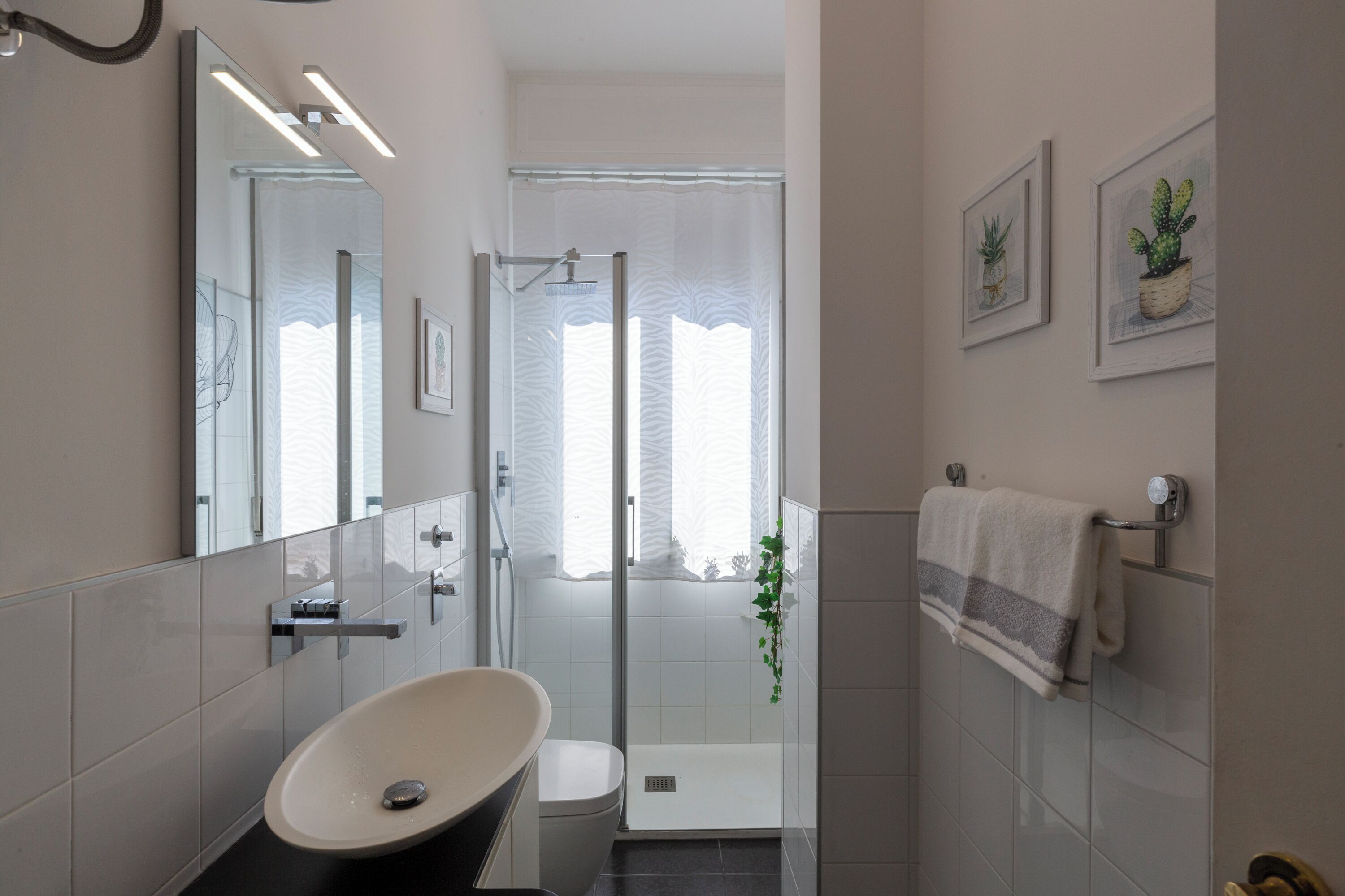 A modern bathroom with a freestanding bathtub, a glass shower enclosure, and a toilet.