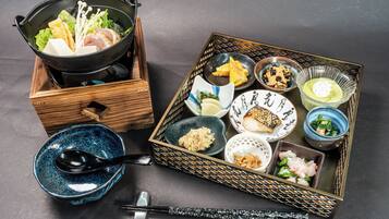 A traditional Japanese meal setup with a variety of dishes and utensils.
