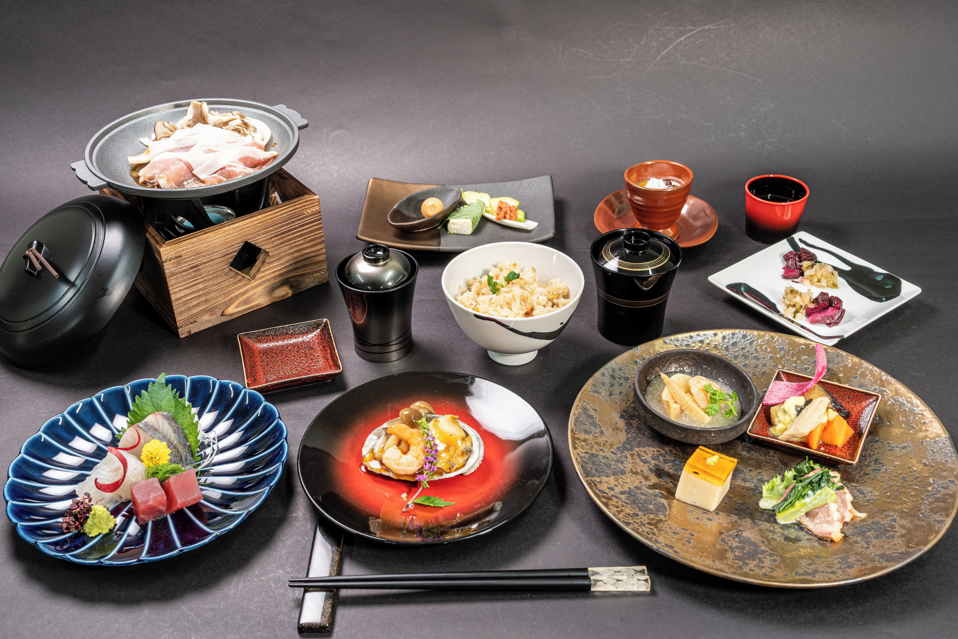 A variety of Japanese dishes and utensils arranged on a table.