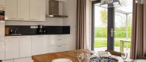 Fridge, stovetop, dishwasher, coffee/tea maker