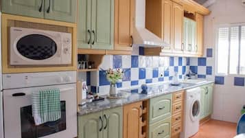 Highchair, cookware/dishes/utensils, spices, lobster pot