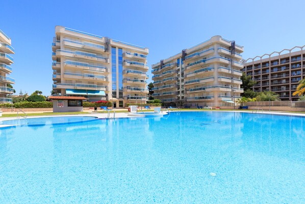 A swimming pool surrounded by high-rise residential buildings.