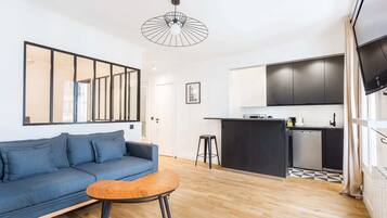 Apartment (7) | Living area | 60-inch TV with cable channels