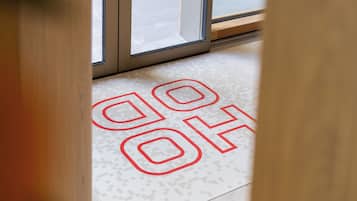 A floor with a geometric pattern and the letters "GO" and "OH" in red.