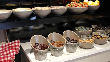 A buffet with various food items and bowls.
