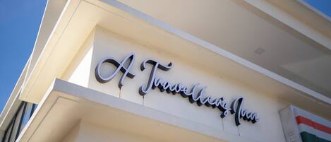 A building with a sign that reads "A Travel Inn".
