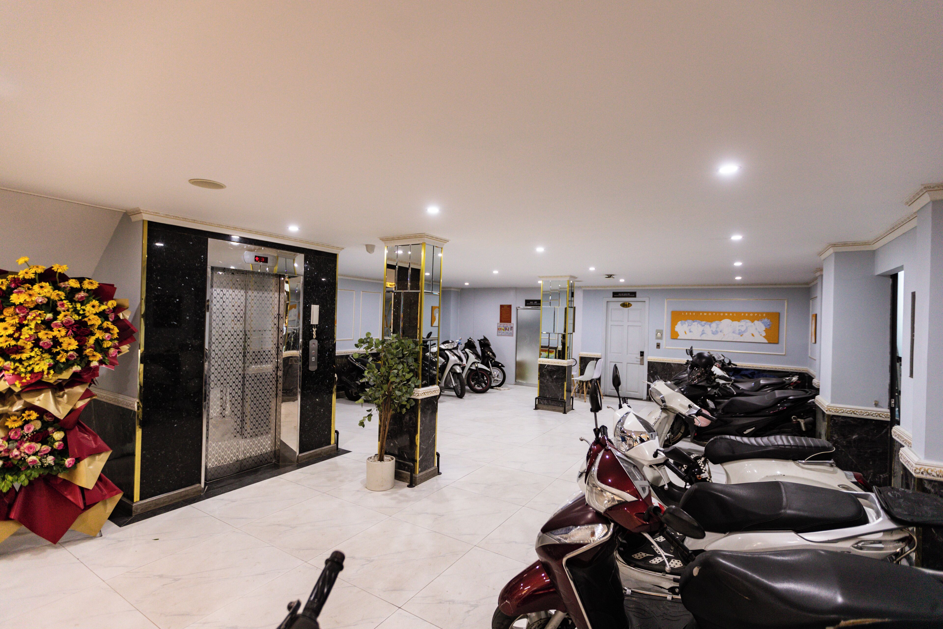 A motorbike rental area with several bikes, a potted plant, and a floral arrangement.
