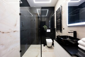 Deluxe appartement (14/8) | Badkamer | Een douche, een regendouche, een haardroger, handdoeken