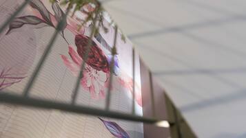 A close-up of a floral wallpaper with a grid pattern.