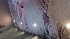 A staircase with a floral mural on the wall. - Opera Boutique (Catania)