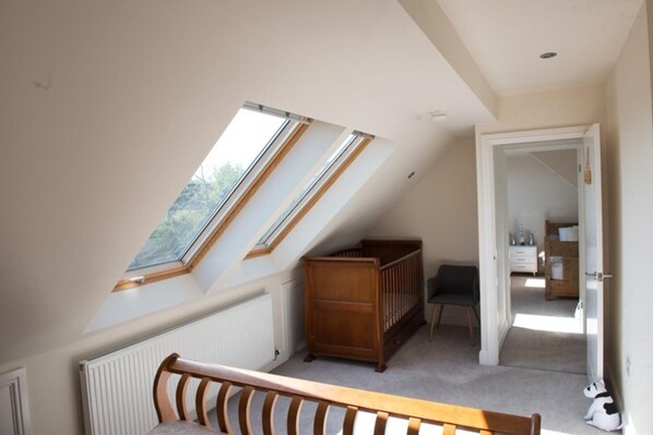 A room with a sloped ceiling, wooden furniture, and a view through skylights. - Mumbles - House - Seaside - Sleeps11 - Petfriendly (Swansea)