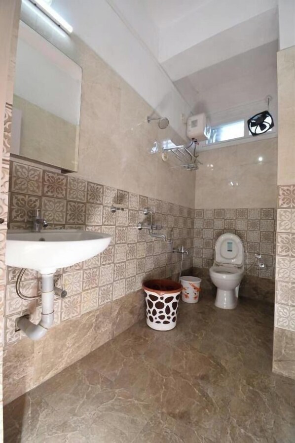 A bathroom with a sink, toilet, and shower. - The Hook BnB (Port Blair)