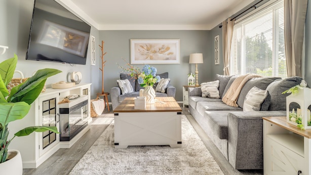 A living room with a flat-screen TV, a coffee table, a sofa, and a fireplace. - Westland Family Home w/ Deck & Fenced Yard (Westland)