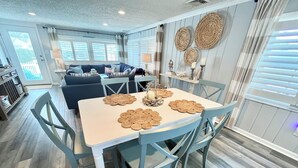 A dining area with a table set for four, surrounded by blue chairs.