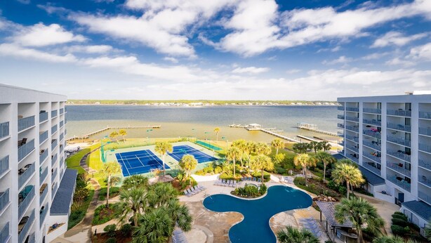 A hotel with a pool, tennis courts, and a view of the sea. - Gulf Shores Surf & Racquet 801a 3 Bedroom Condo (Gulf Shores)