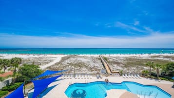 A resort with a pool, beach, and ocean view.
