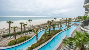 A pool area with a view of the beach and ocean. - Phoenix West 308 3 Bedroom Condo (Orange Beach)
