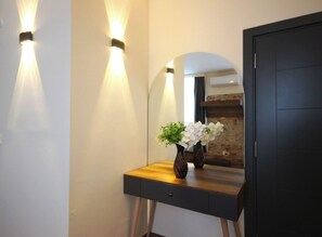 A room with a wooden desk, a mirror, and two wall-mounted lights. - Taxim 34 (Istanbul)