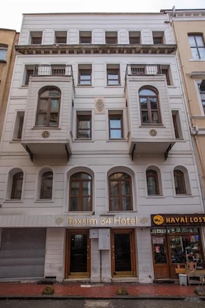 A multi-story building with a sign for "Taksim 34 Hotel" and a shop named "Havai Lost". - Taxim 34 (Istanbul)