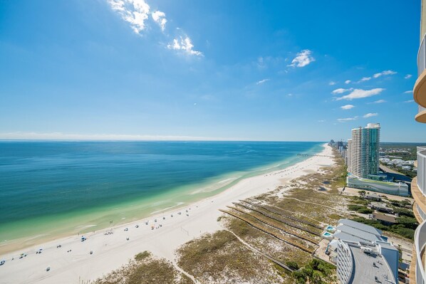 A coastal view with a beach, ocean, and high-rise buildings. - Phoenix Orange Beach Ii 2603-1 1 Bedroom Condo (Orange Beach)