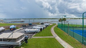A marina with boats docked and a tennis court. - Gulf Shores Surf & Racquet 201b 1 Bedroom Condo (Gulf Shores)