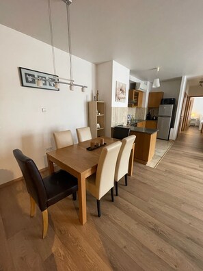 Cozy living space with a dining area, kitchen, and pendant lights.