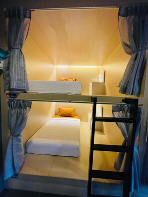 A bunk bed room with a ladder, a desk, and a chair. - Rabbitel Phuket (Phuket)