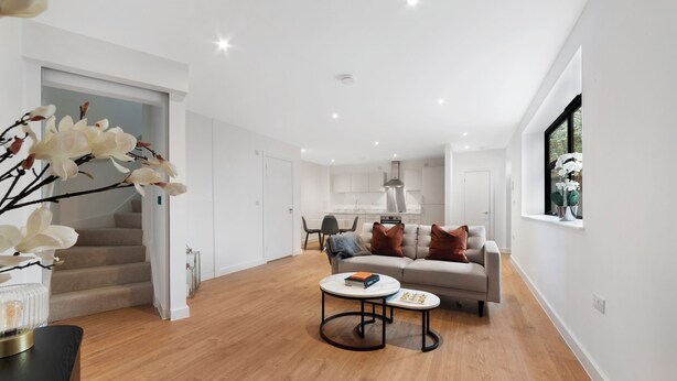 A spacious living area with a sofa, coffee table, and staircase. - Modern Townhouse, Close to 02,excel, 5mins to Tube (London)