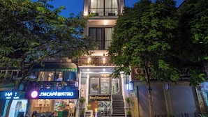 A multi-story hotel with a modern design, featuring balconies and large windows. - Avani Central Hanoi Hotel (Hanoi)
