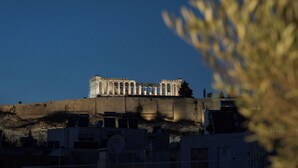 A historical building with classical architecture, featuring columns and a prominent entrance. - Panoramic Acropolis View Suite (Athens)