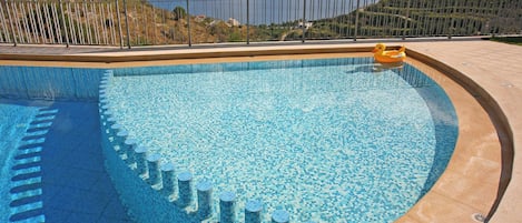Seasonal outdoor pool, pool umbrellas, pool loungers