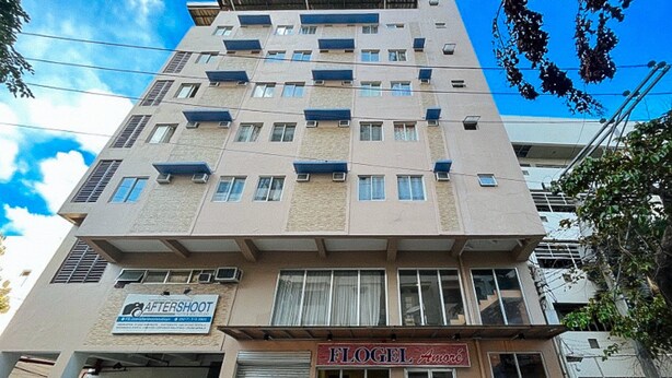 A multi-story building with a sign for 'AFTERSHOOT' and 'FLOGEL Amore'. - Flogel Amore Pension House (Cebu City)