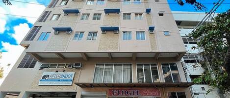 A multi-story building with a sign for 'AFTERSHOOT' and 'FLOGEL Amore'.