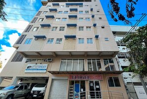 A multi-story building with a sign for 'AFTERSHOOT' and 'FLOGEL Amore'. - Flogel Amore Pension House (Cebu City)