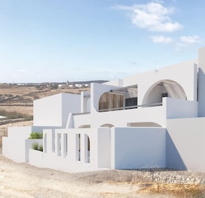 A modern white building with a flat roof, large windows, and a view of the surrounding landscape. - Mr & Mrs White Paros Suites & More (Paros)