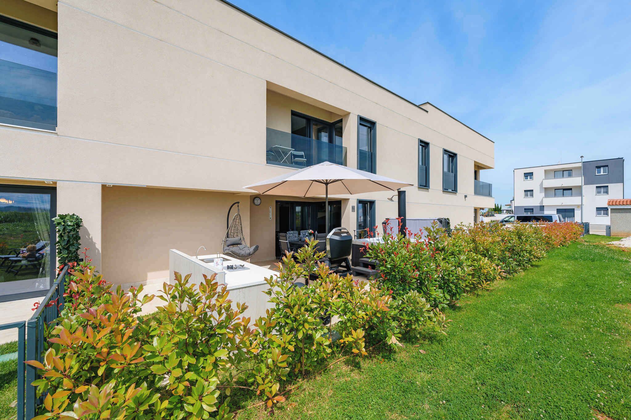 A modern building with a patio area featuring outdoor seating and a barbecue grill.