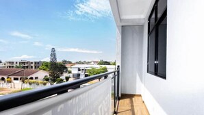 A balcony with a view of buildings and a clear sky. - 2 bed flat, near the airport (Accra, Greater Accra Region)