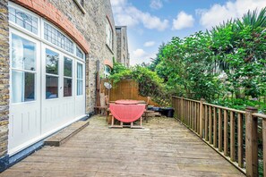 Enjoy outdoor dining or relaxation on the deck with a table and chairs.