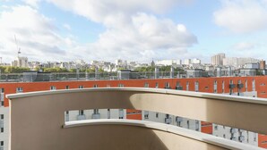 A high-rise building with multiple balconies and a cityscape view in the background. - Nice apartment with balcony in Pré-Saint-Gervais (Le Pré-Saint-Gervais)