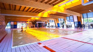 A large indoor swimming pool with tiled floors and wooden beams. - Cozy Chalet With a Combination Microwave (Breskens)
