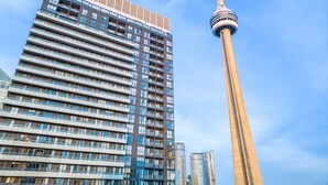 A high-rise building with a modern architectural design, featuring multiple floors with balconies and a prominent tower structure in the background. - Bluejaysway (Toronto)