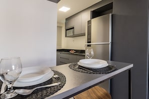 Apartment | Private kitchen | Fridge, microwave, stovetop, cookware/dishes/utensils