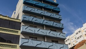 A multi-story building with a modern architectural design, featuring balconies on each floor. - Duque by My Way (Porto Alegre)