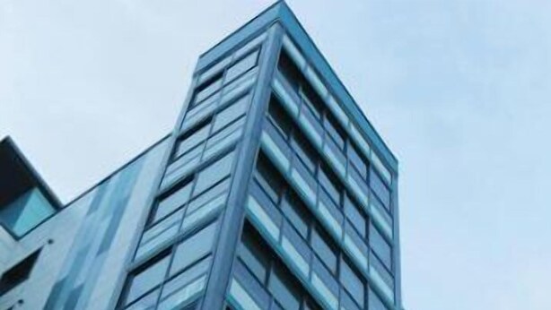 A modern high-rise building with a glass facade and a geometric design. - Delightful 3-bedroom apartment with AC and fitness room in Gurugram (Gurugram)